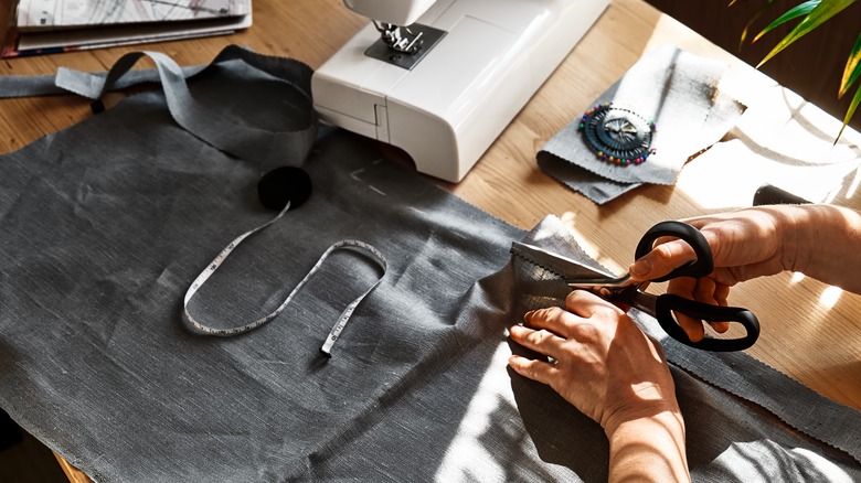 Woman cutting and sewing fabric