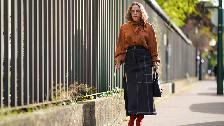 woman wearing denim midi skirt