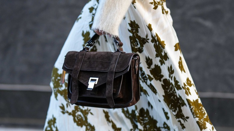 woman wearing brown suede bag