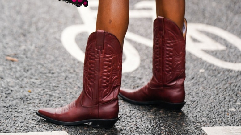 woman with burgundy cowboy boots