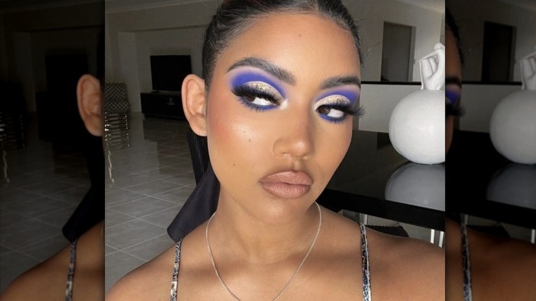 Woman models cobalt blue eyeliner