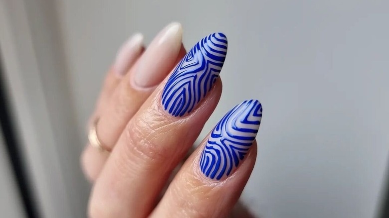 Hand with cobalt blue line art nails