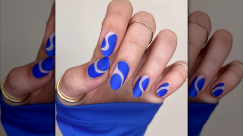 Hand with cobalt blue manicure