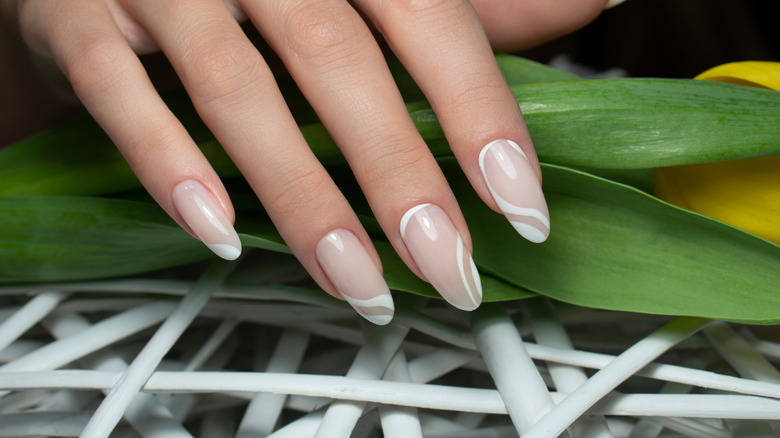 hand with coconut milk nails