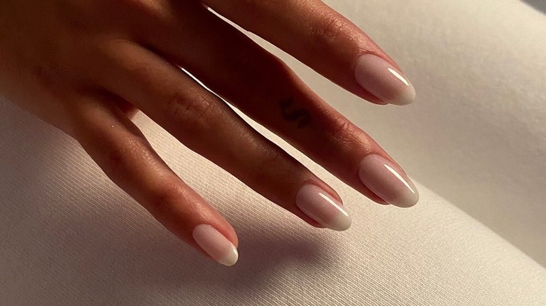 hand with coconut milk nails