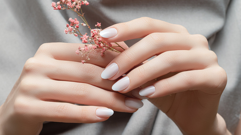 hands with coconut milk nails