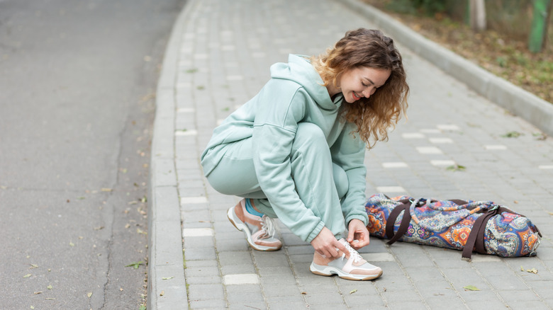 woman tying shoelaces