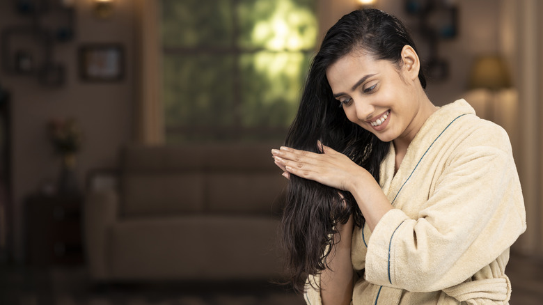 woman rubbing product on hair