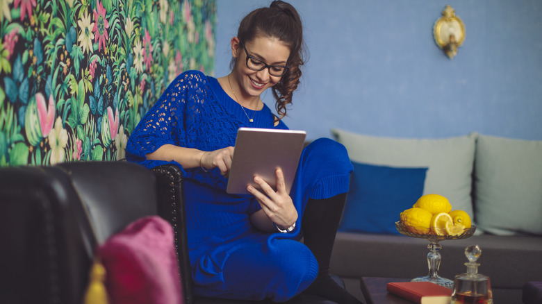 Woman wears blue in blue room