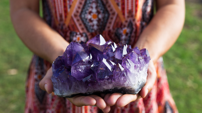 Woman holds amethyst geode 