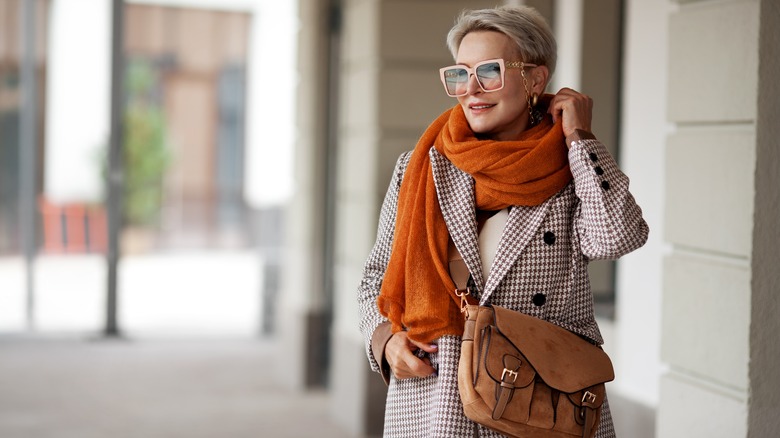 Woman wears orange scarf