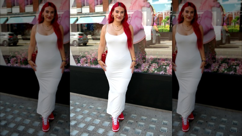 Megan Bolton wearing white dress and red sneakers