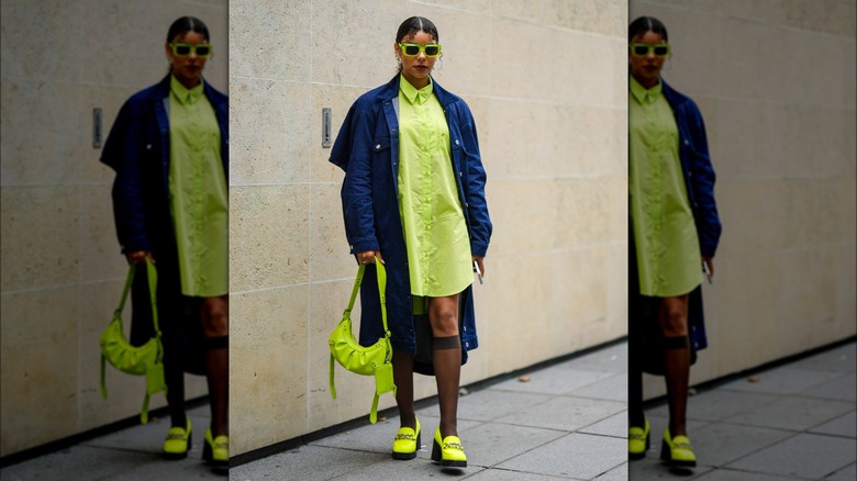 woman wearing neon loafers
