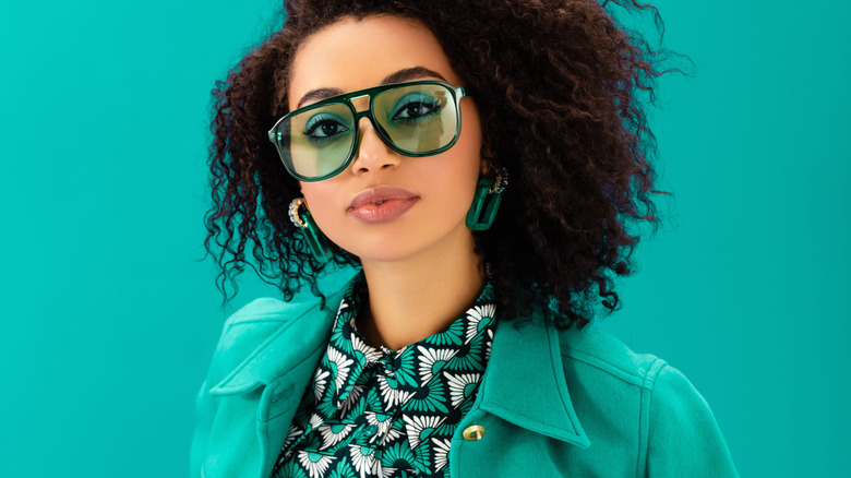 Beautiful woman wearing green sunglasses