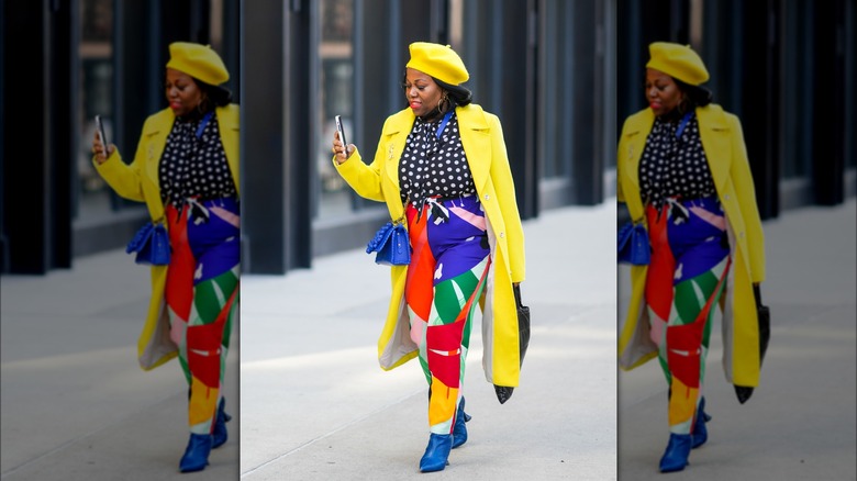 Woman wearing bright yellow coat and beret