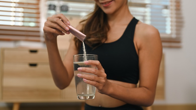 woman adding powder to water