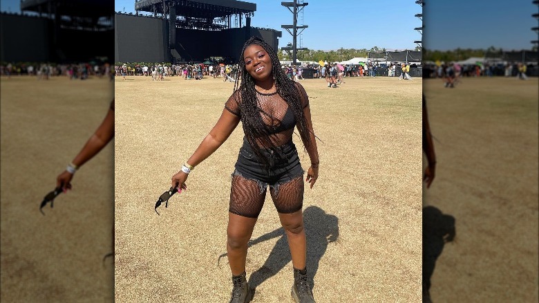 Woman wearing black mesh outfit