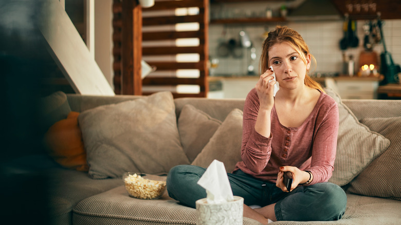 Woman crying while watching TV