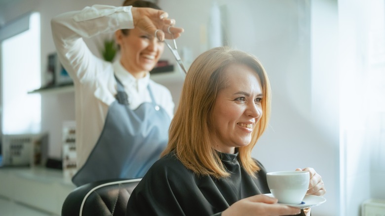 Woman having hair cut