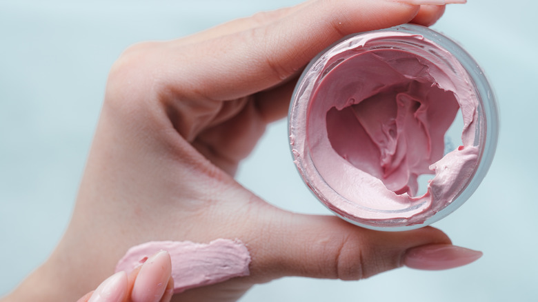 A woman holding color corrector