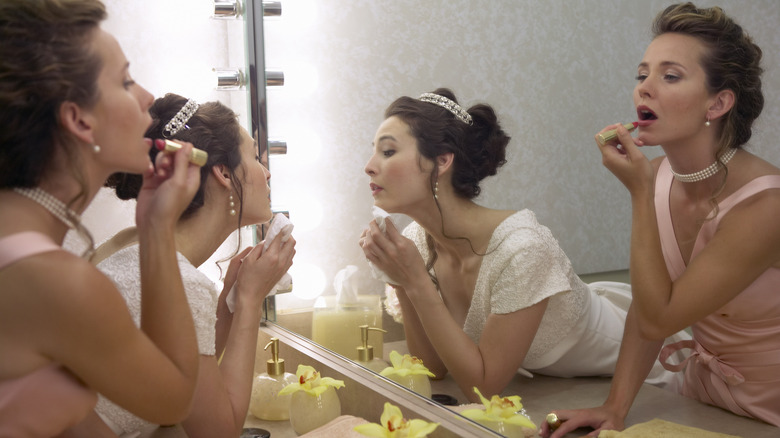 Two women fixing their makeup