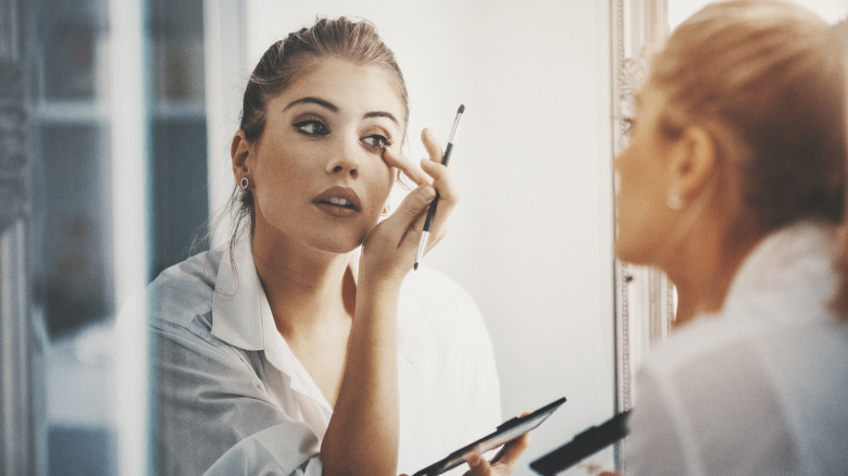 A woman doing her makeup