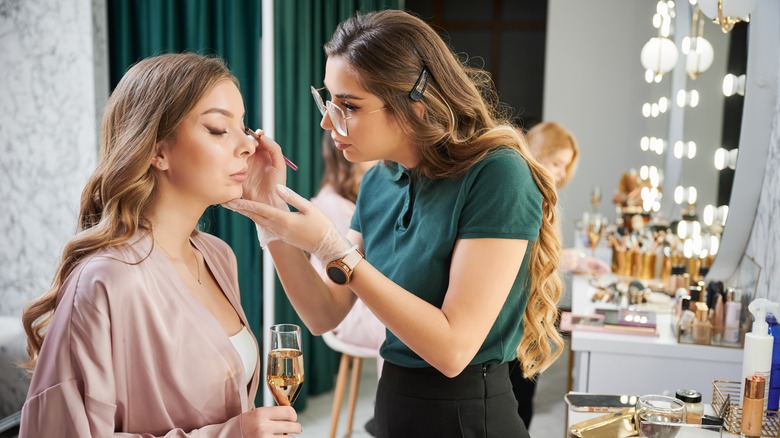 A woman getting her makeup done