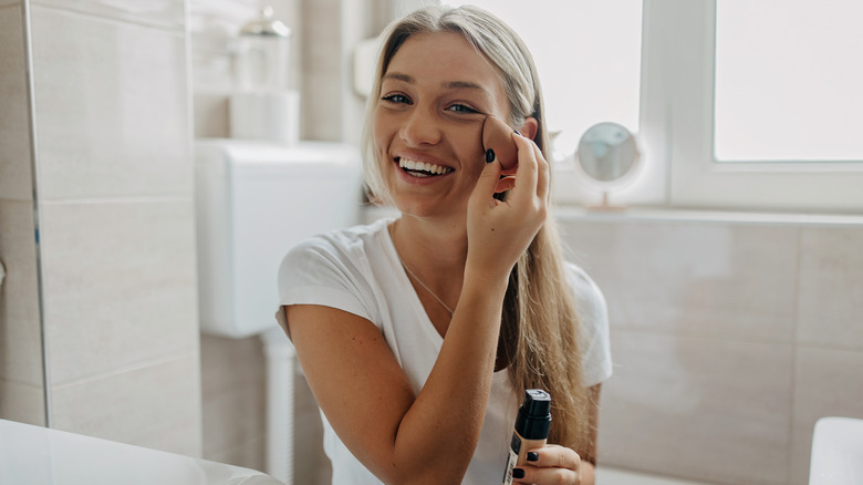 A woman applying foundation