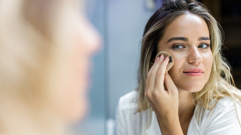 A woman applying her makeup