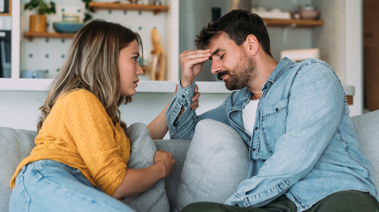 sad couple on couch