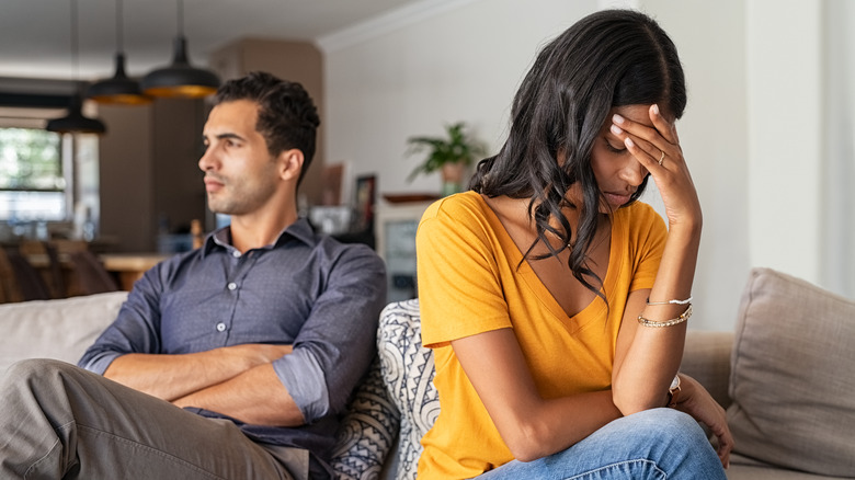 sad couple on couch