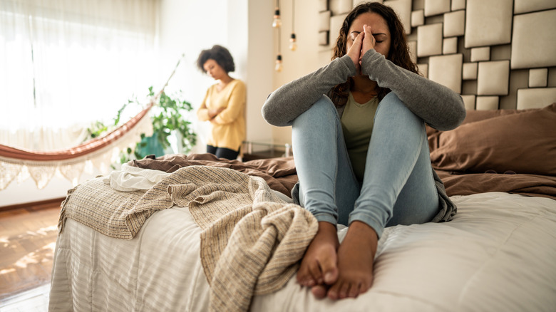 Two women upset in a bedroom