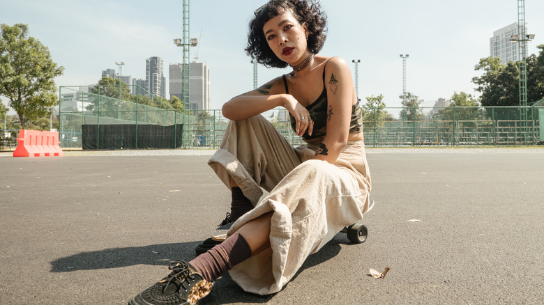 Tattooed Asian woman in street clothes