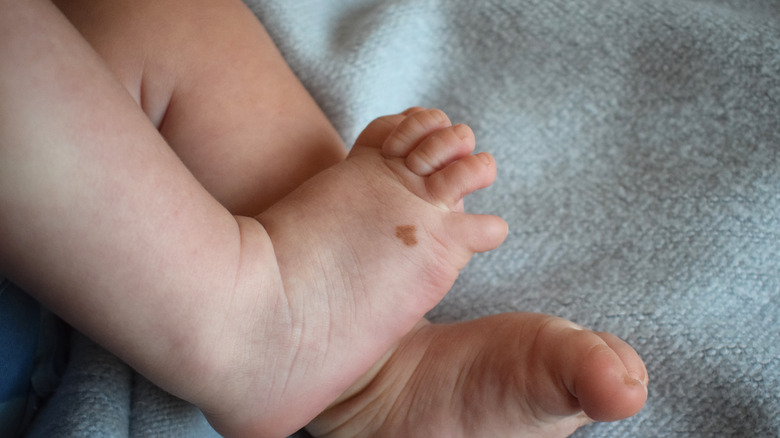 Close up of baby's feet with heart-shaped mole