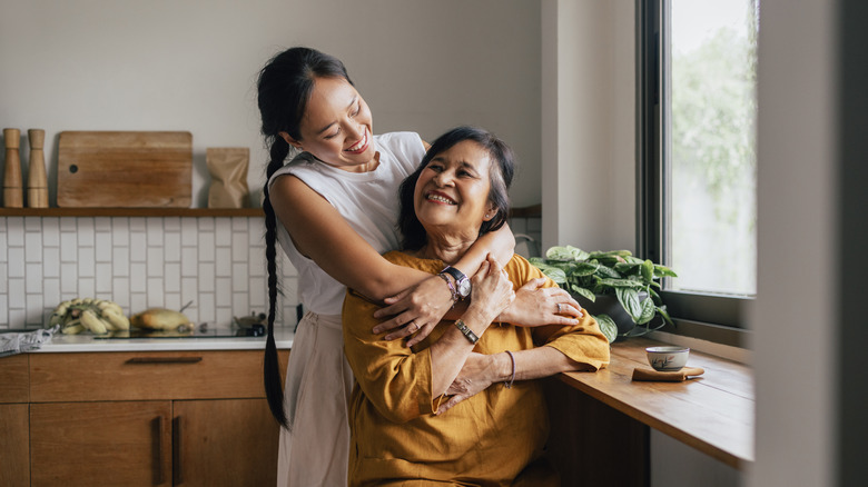 Mom and adult daughter hugging