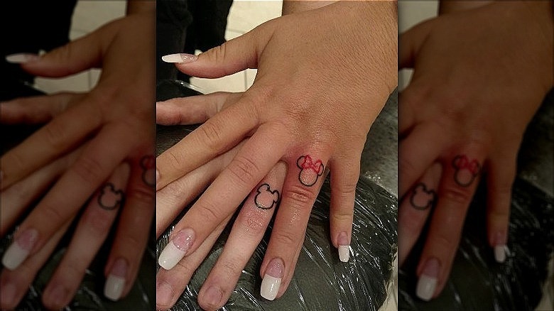 couple with mickey minnie wedding ring tattoos