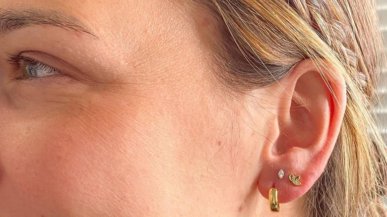 Woman with ear constellation piercings