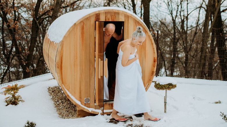 Couple leaving outdoor sauna