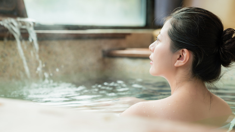 Woman bathing in warm bath