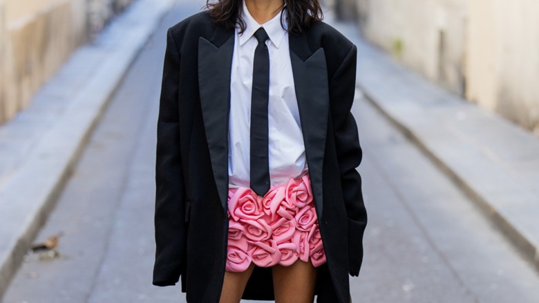 woman wearing blazer and rose skirt