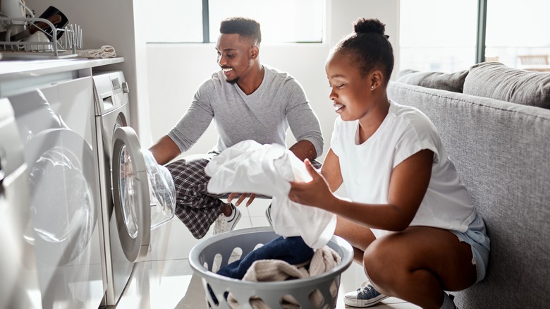 Black couple doing laundry