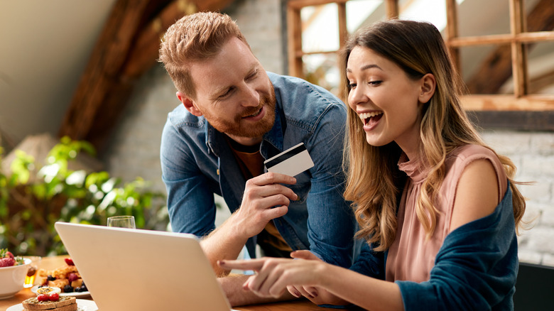 Happy couple discussing online purchase