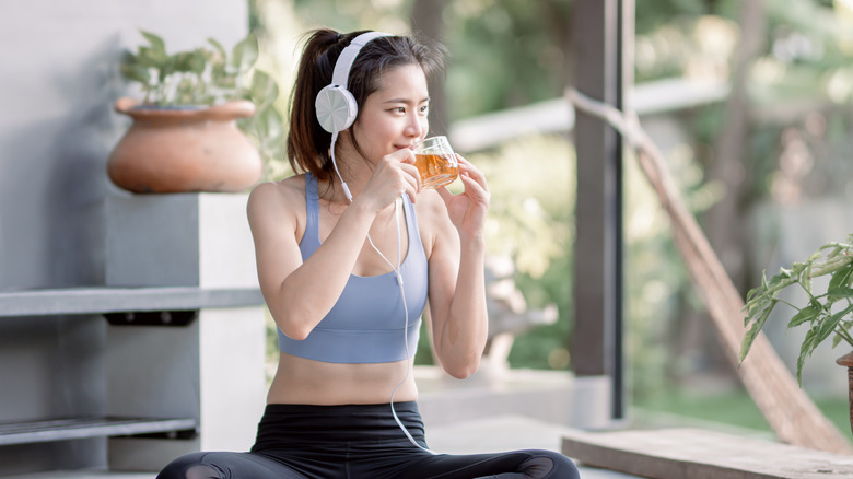 Woman drinking tea and meditating