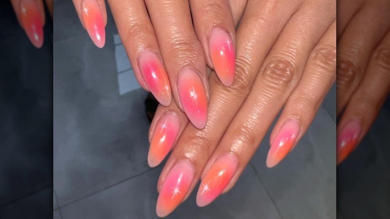woman wearing coral ombré nails
