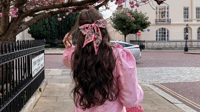 Woman with long, curly hair in bow