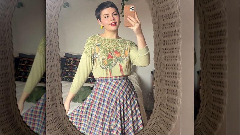 Woman with pixie cut taking mirror selfie