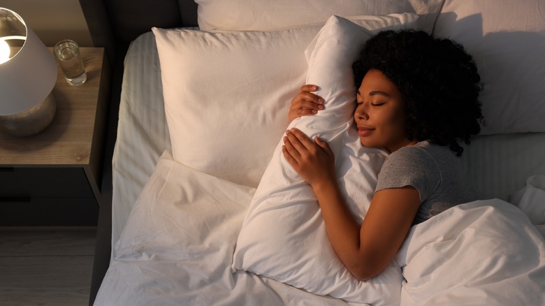 Woman sleeping with night light