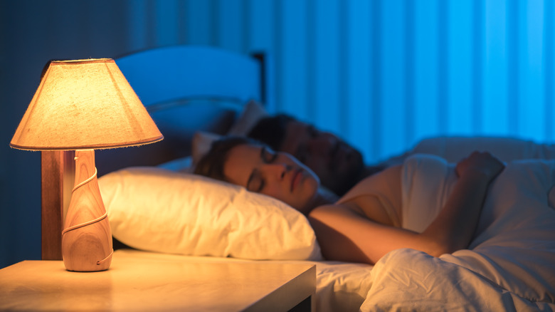 Woman using lamp at night