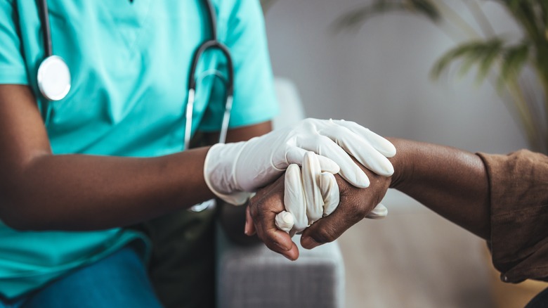 doctor examining nail psoriasis