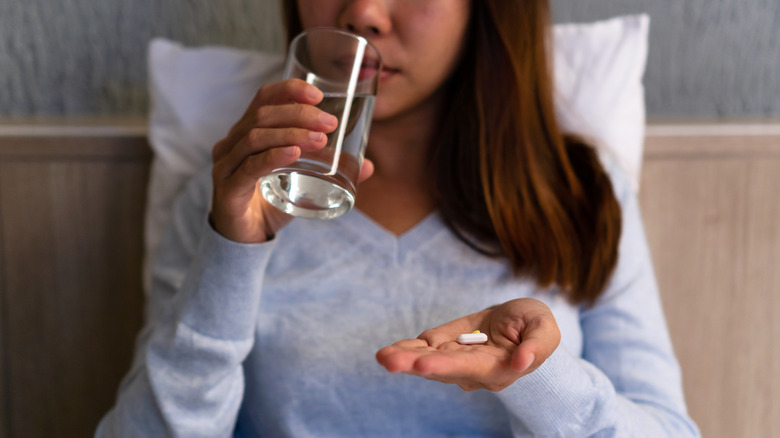 woman taking pills